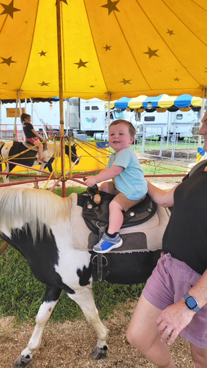 Child enjoying the Commerford Petting Zoo pony rid